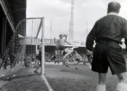 The referee keeps a close watch as Ian Buxton takes a tumble