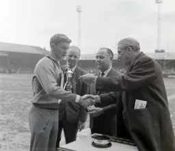 Terry Branston gets a medal to go with the trophy