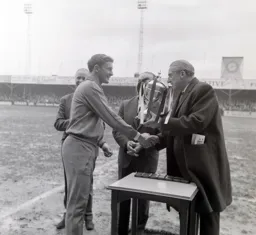 Skipper Terry Branston being presented with the trophy