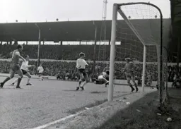 Oldham keeper David Best prevents a certain goal as Alan Slough looks on