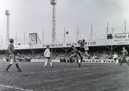 Alan Hill punches the ball clear under pressure from Laurie Sheffield