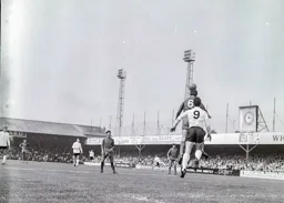 Brian Tiler heads the ball clear away from Laurie Sheffield