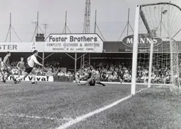 United keeper Alan Hill makes a save as Laurie Sheffield follows up