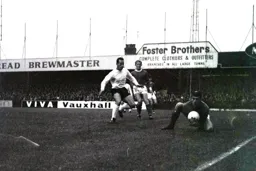 Barnsley keeper Brian Arblaster gathers the ball as Laurie Sheffield awaits in case of a slip up