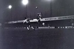 Laurie Sheffield can only watch as Eric Brookes head the ball clear