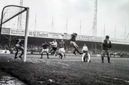Brian Lewis misses the ball but Laurie Sheffield will put the ball into the net