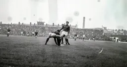 No way through for Brian Lewis as Jim Cumbes scoops the ball off the waterlogged surface