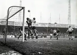 Brian Lewis and Ray Pointon duel for the ball under the crossbar but the ball stayed out