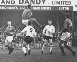 Brian Lewis and Laurie Sheffield watch as the goalkeeper gathers the ball