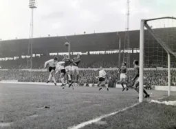 Bruce Rioch goes up against two defenders