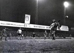 Brian Lewis watches as Eric Barnes heads the ball clear for Crewe