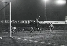 John Phillips punches the ball clear as Mike Keen looks on