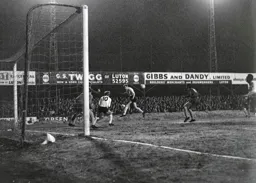 Mike Keen heads the ball across the penalty area