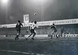 Keith Allen heads the ball forward into the path of Laurie Sheffield