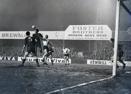 The ball is headed clear from Laurie Sheffield