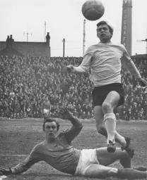 Brian Lewis hurdles a defender