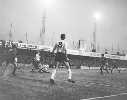 Brian Lewis is tackled inside the penalty area