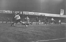 Laurie Sheffield attempts to deflect as shot by Alan Slough