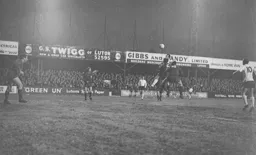 Laurie Sheffield gets above Brian Arrowsmith to send a header towards the goal