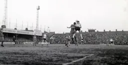 Keith Allen looks to head the ball into the path of Bruce Rioch