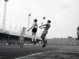 Keith Allen attempts to flick the ball on but Keith Eddy is able to block it