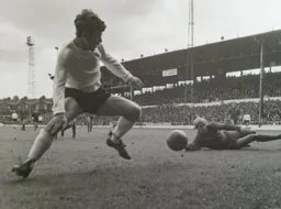 Malcolm Macdonald rounds the keeper