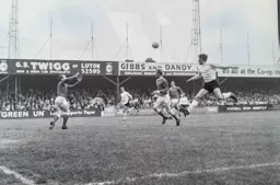 Malcolm Macdonald heads across goal