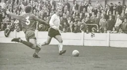 John Collins gets to the ball first