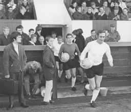 Mike Keen leads the team out followed by Sandy Davie