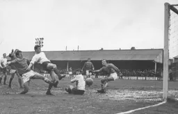 Viv Busby ploughs through the mud to net the Town's opener