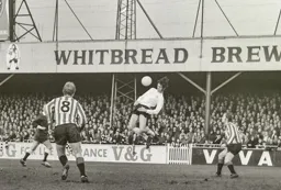 Don Givens lays off a header