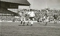 Malcolm Macdonald goes past his man