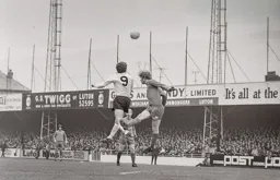Malcolm Macdonald wins the ball in the air