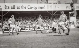 Malcolm Macdonald slides to get his shot off