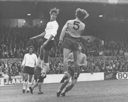Chris Nicholl shows determination to clear the ball