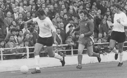 Chris Nicholl clears the danger watched by Alan Slough