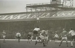 Don Givens (9) watches Peter Anderson's header