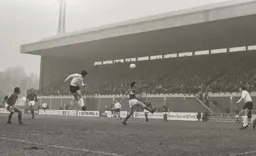 Don Givens heads across goal