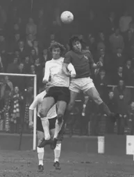 Robin Wainwright goes up for a header