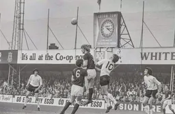Viv Busby challenges the Burnley midfielders