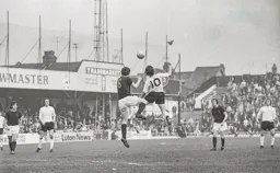 Don Givens goes head to head with Burnley's Martin Dobson
