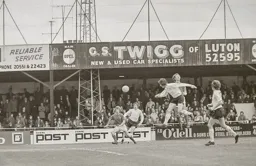 Don Givens heads across goal