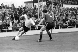 Vic Halom tries to keep his feet while going down the wing