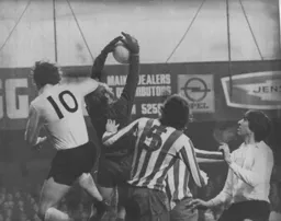 Peter Grummett in the Wednesday goal holds on to the ball under pressure