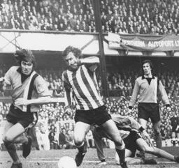 John Ryan tackles Sunderland's Dennis Tueart
