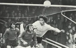 Alan Garner is first to the ball