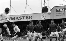 Viv Busby heads across goal