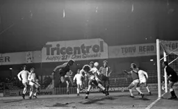 Barry Butlin tries to guide his header through the massed ranks