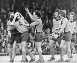 Town players congratulate scorer of the second Barry Butlin