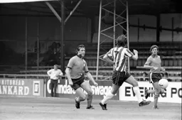 Gordon Hindson chases a through ball watched by Bobby Thompson